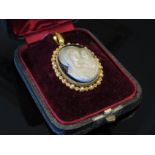 A cameo pendant depicting the Virgin Mary and baby Jesus,