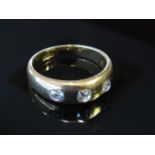 An 18ct gold ring set with three diamond in rub over setting .60ct total approximately, size Q, 6.