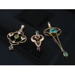 Three Art Nouveau pendants including peridot and ruby examples two stamped 9ct.