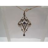 An Edwardian seed pearl and amethyst pendant/brooch stamped 9ct hung on chain
