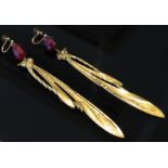 A pair of Art Nouveau large dragonfly drop earrings in metal gilt with faceted red amber bead tops,