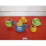 A multi coloured dolls tea service