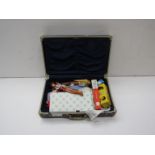 A case containing various dolls and boxed Ping Pong balls