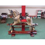 A Victorian F H Ayres painted wooden dappled rocking horse on pine trestle rocker 150cm length