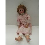 A Heubach Koppelsdorf bisque head girl doll on jointed composition body