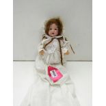 An Armand Marseille bisque headed toddler doll marked 9 90 AM6/0