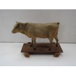 A Victorian pull-along toy cow on wheels a/f