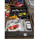 A box of diecast vehicles including Maisto