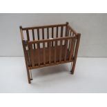 A hand made dolls cot with brass fittings