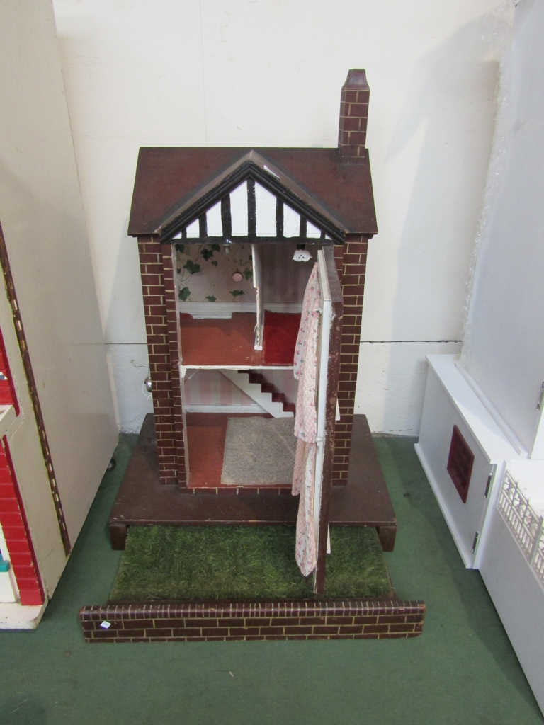 An Edwardian handmade doll house with slide out lawn,