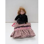 A German bisque doll with crown stamp and black velvet jacket