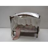 An early 20th Century hand made four poster dolls bed with acorn finials