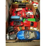 A box of diecast vehicles including Maisto