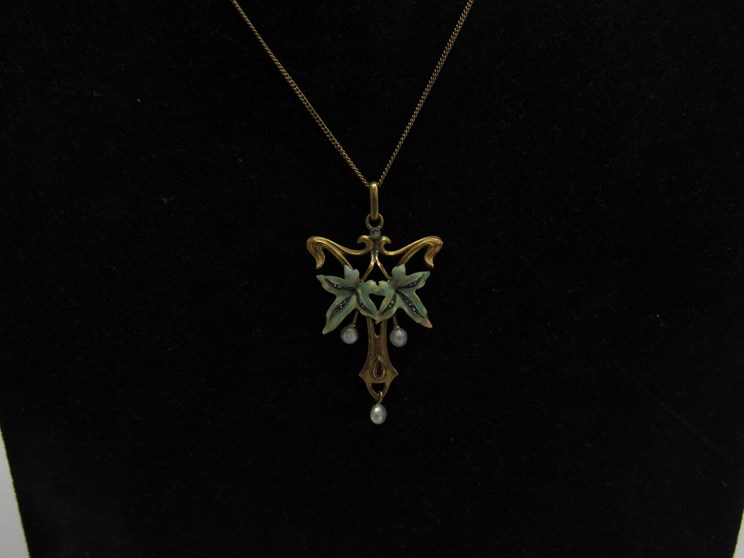 A 19th Century Art Nouveau pendant on chain, set with ruby, pearl and diamond, unmarked,