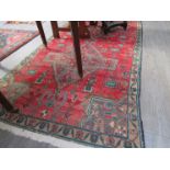 A mid-late 20th Century Eastern wool rug worked with two large lozenges to the other central field