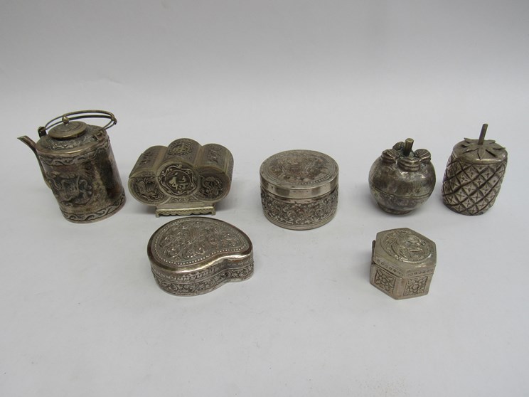 Seven Cambodian white metal ornamental trinket pots including chest form,