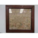 A Victorian silkwork sampler worked in cross-stitch on a canvas ground, with cases of the alphabet,