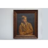 An early 20th Century oil on canvas portrait of a young boy in tan work coat. Unsigned work.