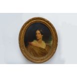 A 19th Century oil on canvas set in an ornate gilt oval frame, portrait of a young woman,.
