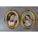 A pair of late 19th century oval oils on card portraits of young women with flowers in their hair.