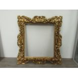 A 19th Century carved giltwood Florentine frame wih mask corners.
