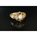 A 15ct gold ring, the ornate mount set with garnets and moonstones, engraved shoulders, size O, 2.