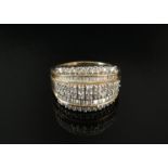 A 9ct gold ring set with multiple bands of brilliant and baguette cut diamonds. Size P, 5.