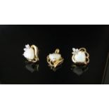 A gold pendant set with a heart shaped opal with a pair of matching earrings stamped 750,