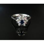 A white gold diamond and sapphire cocktail ring, stamped 750. Size P, 3.