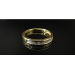 A gold half hoop baguette diamond ring stamped 18K, size O/P, 2.