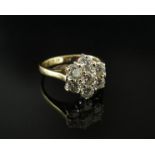A diamond daisy ring 1.10ct total approx, shank stamped 750. Size J, 3.