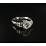 A platinum Art Deco diamond ring, the central diamond 1ct approx flanked by baguette cut diamonds.