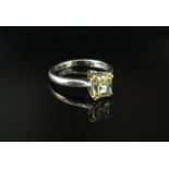 An 18ct white gold ring set with set a single canary yellow diamond emerald cut 5.9mm x 5.3mm, 1.