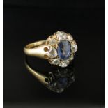 A gold ring set with old cut diamonds and sapphire to centre, marked 18c. Size O, 4.