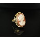 A gold cameo ring in fancy mount, stamped 750. Size Q, 5.