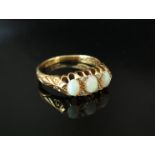 An 18ct gold ring with three opals separated by two diamonds. Size M, 3.