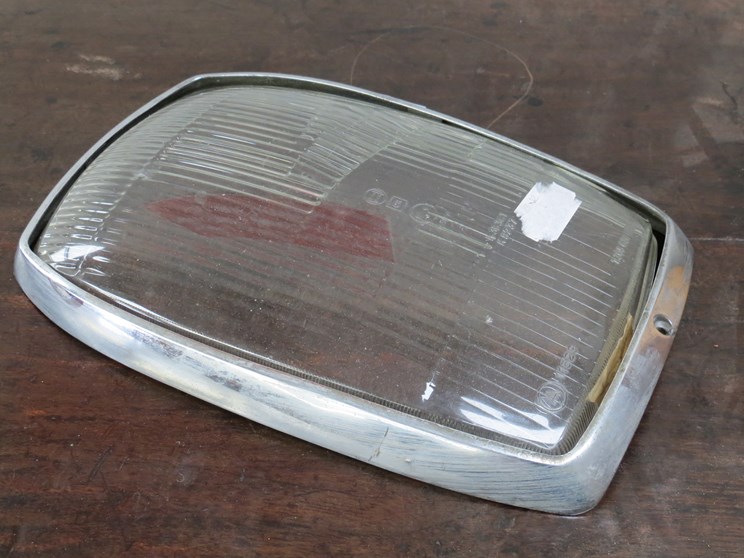 A Bosch lamp lens with chrome surround for Mercedes Benz