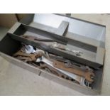 A box of mixed tools including spanners