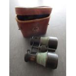 A pair of early Le Chauffeur drivers binoculars in leather case