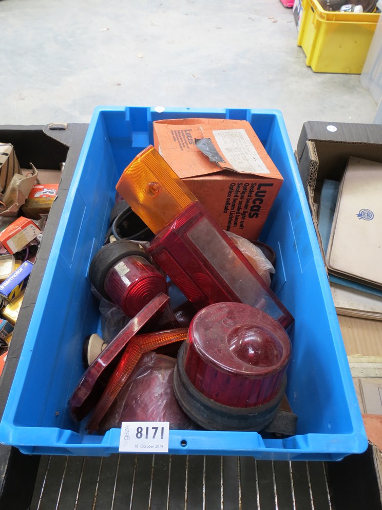 A box containing a quantity of lamps and lenses including a 7" Lucas sealed beam unit