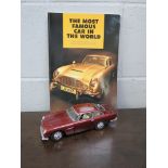 A boxed 1964 Aston Martin DB5 model and a copy of Dave Worrall 'The most famous car in the world'