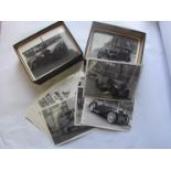 Two boxes of historical black and white photographs of various vintage and classic vehicles