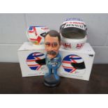 A boxed ceramic Nigel Mansell crash helmet and mug along with a Nigel Mansell figurine