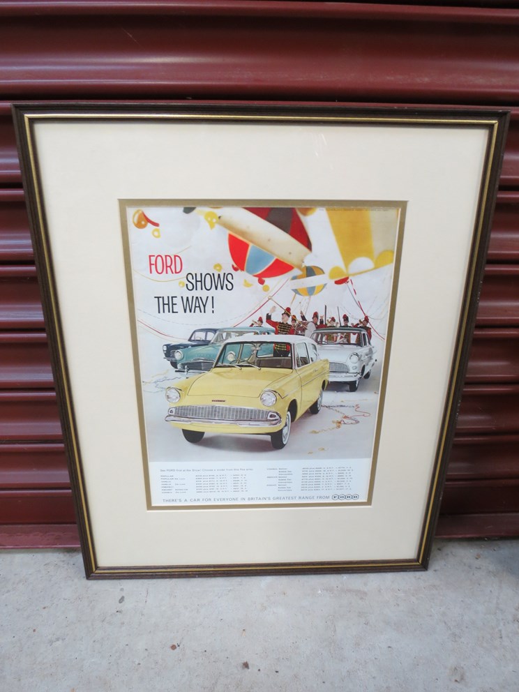 Two framed and glazed Ford show "Be the first on the road with Ford" advertisements