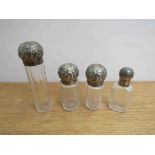 Four silver topped dressing table bottles with monogrammed tops,
