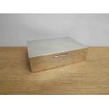 A William Neale & Son Ltd a silver cigarette box of plain form, Birmingham 1964. 17cm x 11.5cm x 4.