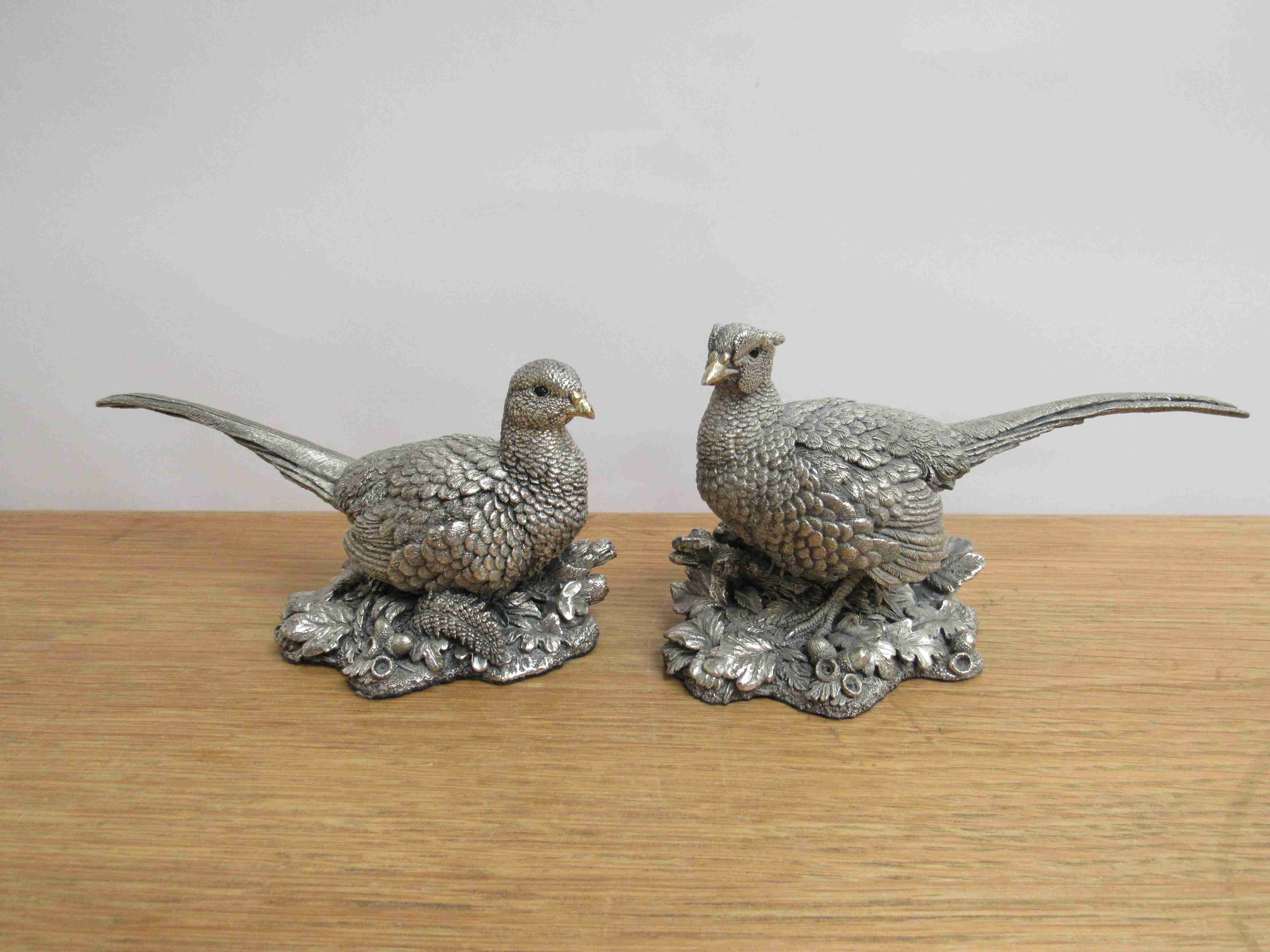 A pair of filled sterling silver pheasant figures approx 19cm long