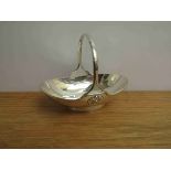 A Mappin & Webb silver basket with fixed handle of boat form, base set with floral roundels,