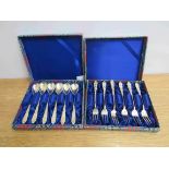 A cased set of six forks and cased set of six spoons both marked UD 800 Deluxe