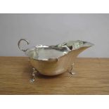 A Martin Hall & Co Ltd silver sauce boat, shaped rim, scroll handle, three feet, Sheffield 1914,